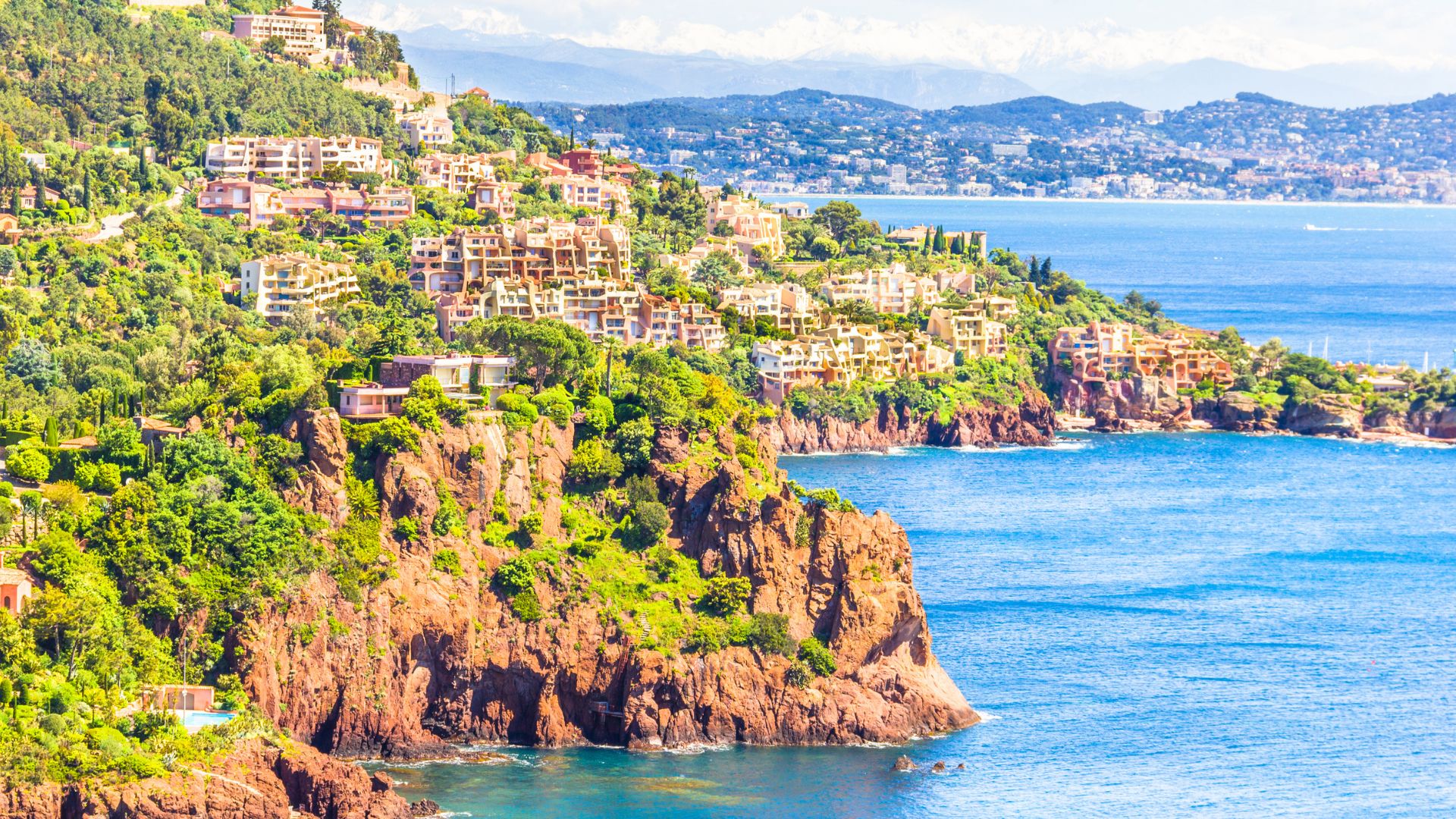 The Esterel stretch matters because it gives the route a coastline, not only a sequence of famous quays. Théoule's red rock is the visual break that keeps the week from becoming only boulevard and berth.