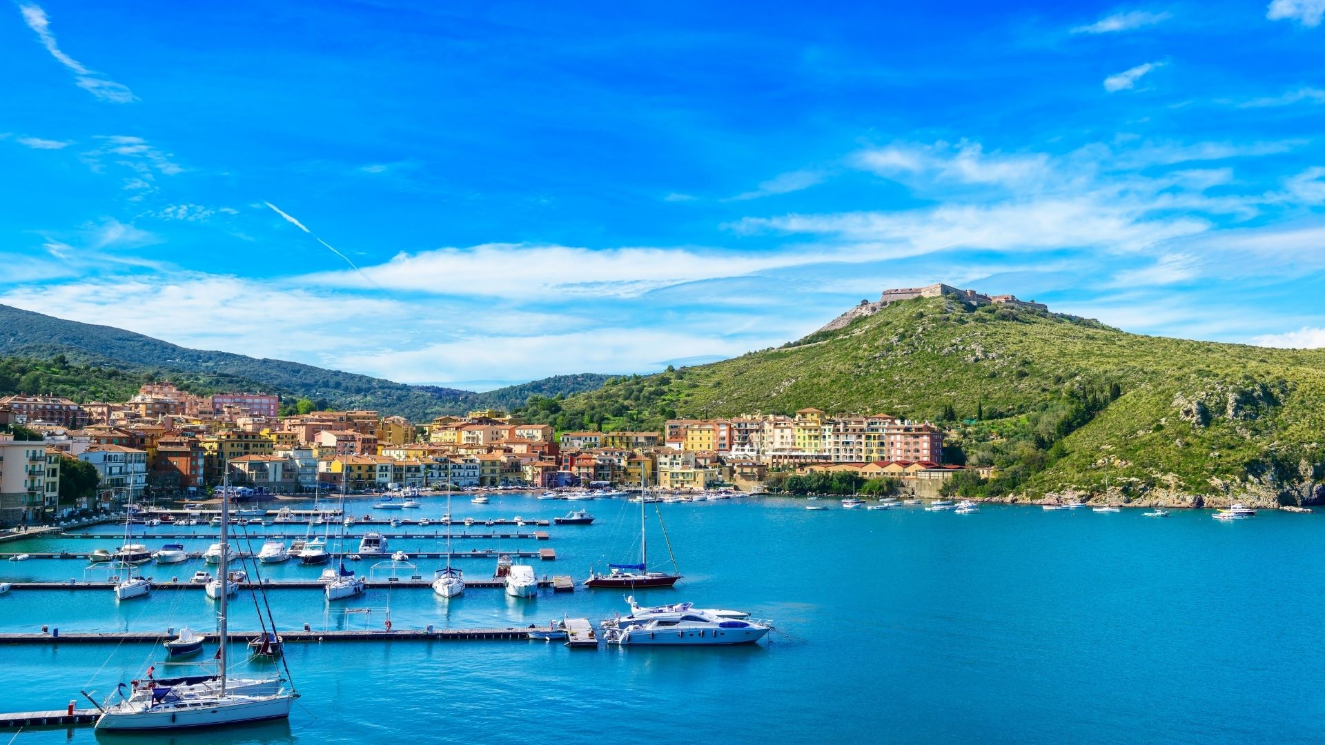 Porto Ercole — the eastern of the Argentario peninsula's two harbor towns, fortified by the Spanish in the sixteenth century with three Forts (Filippo, Stella, Rocca) ringing the headland. Caravaggio died here in July 1610; the small church on the harbor street holds the local memorial.