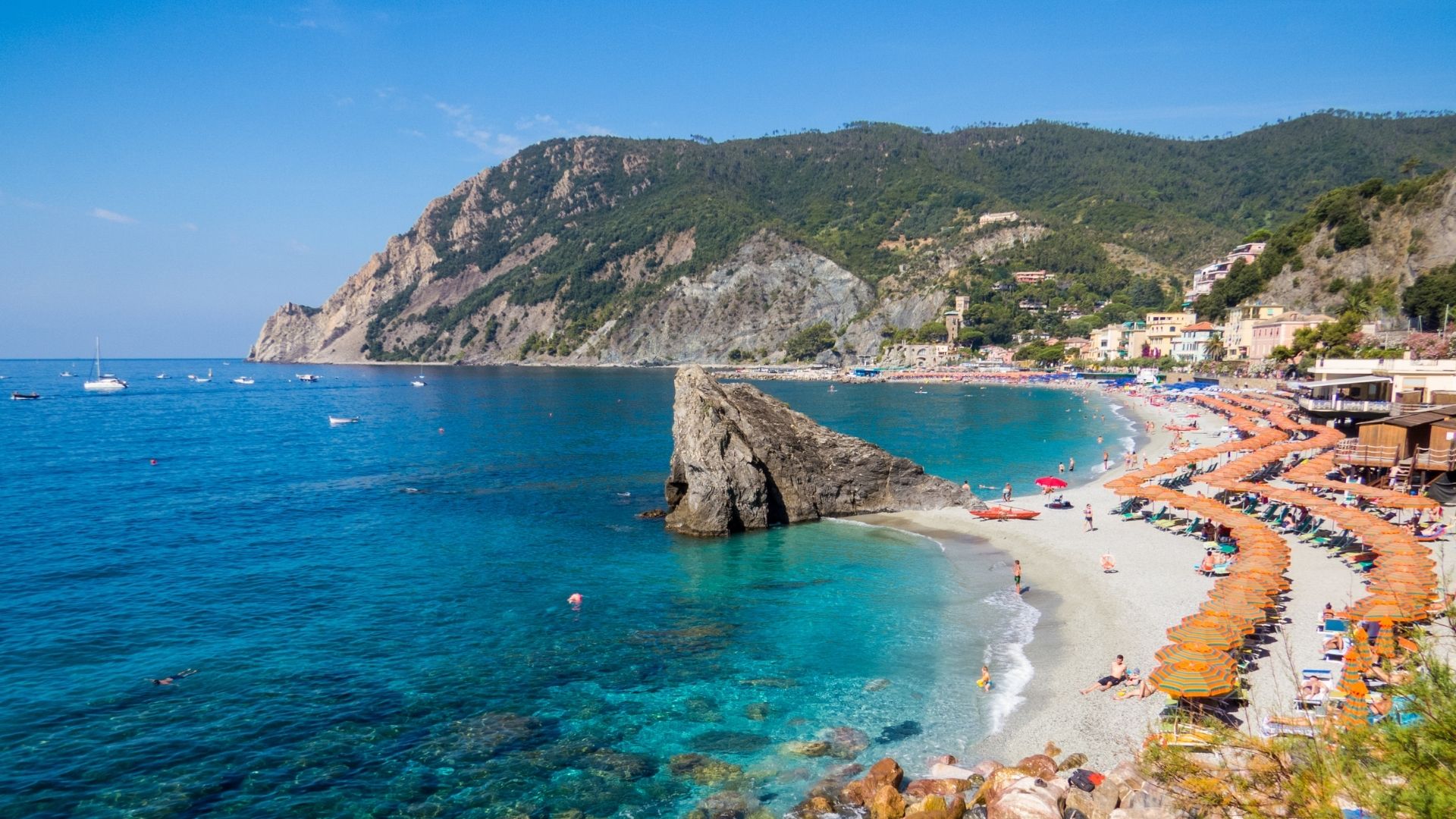 Monterosso al Mare — the only one of the five Cinque Terre villages with a proper beach. Split between Fegina (the newer side, where the train station and the beach are) and Vecchio (the medieval quarter on the eastern end). The cleanest first-night overnight in the Cinque Terre stretch.