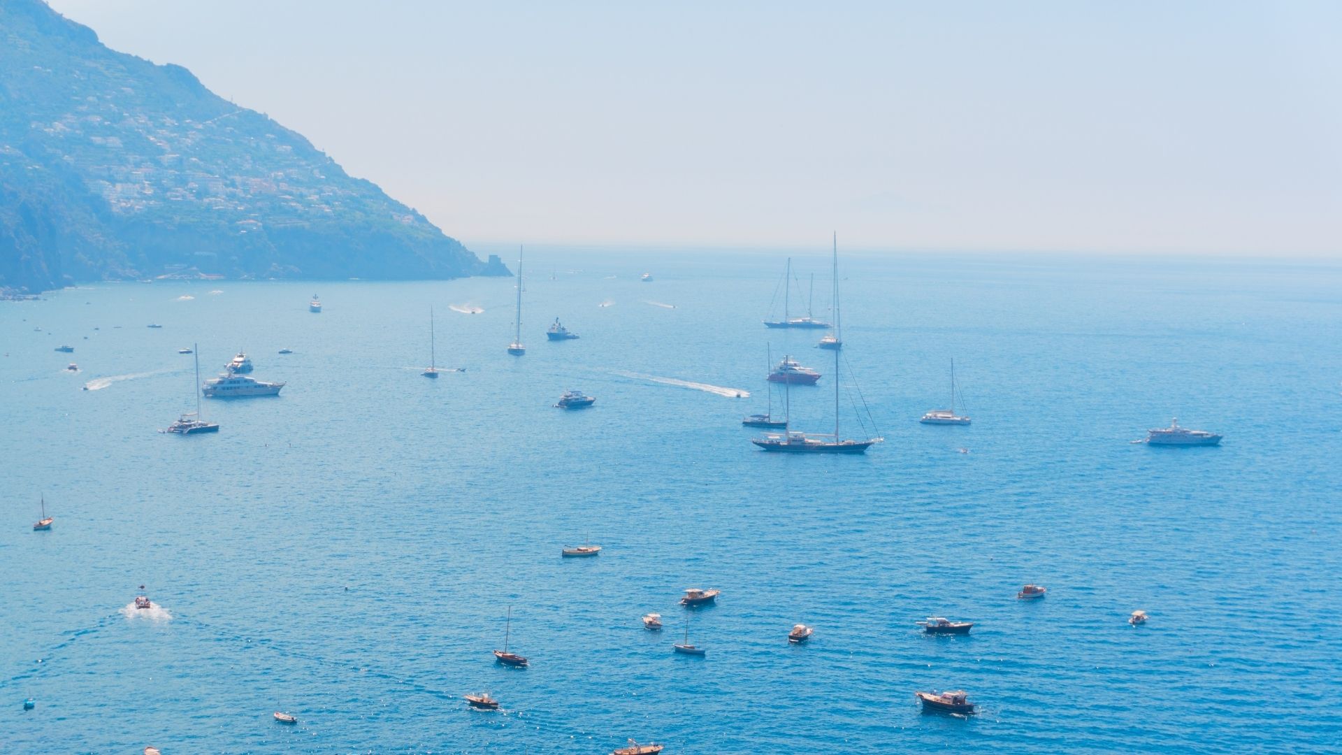 Crewed motor yacht running off the Cinque Terre coast on the Italian Riviera