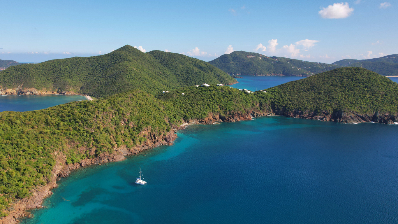 Explore Muskmelon Bay, Guana Island: a picturesque BVI anchorage with vibrant marine life, stunning cliffs, and excellent snorkeling. Perfect for a lunch stop.