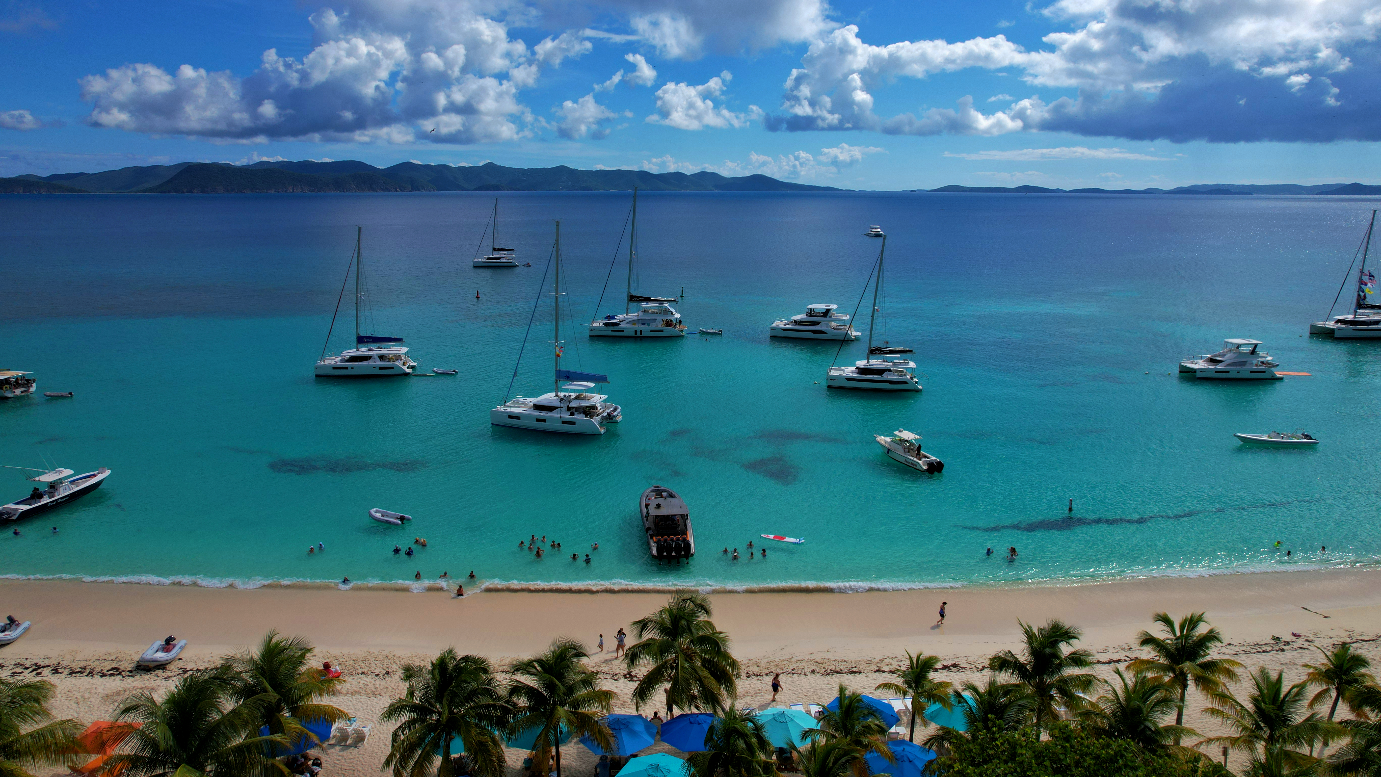 Experience White Bay, Jost Van Dyke: Beautiful beach, lively bars, and the original Painkiller at Soggy Dollar Bar. Perfect for relaxing.