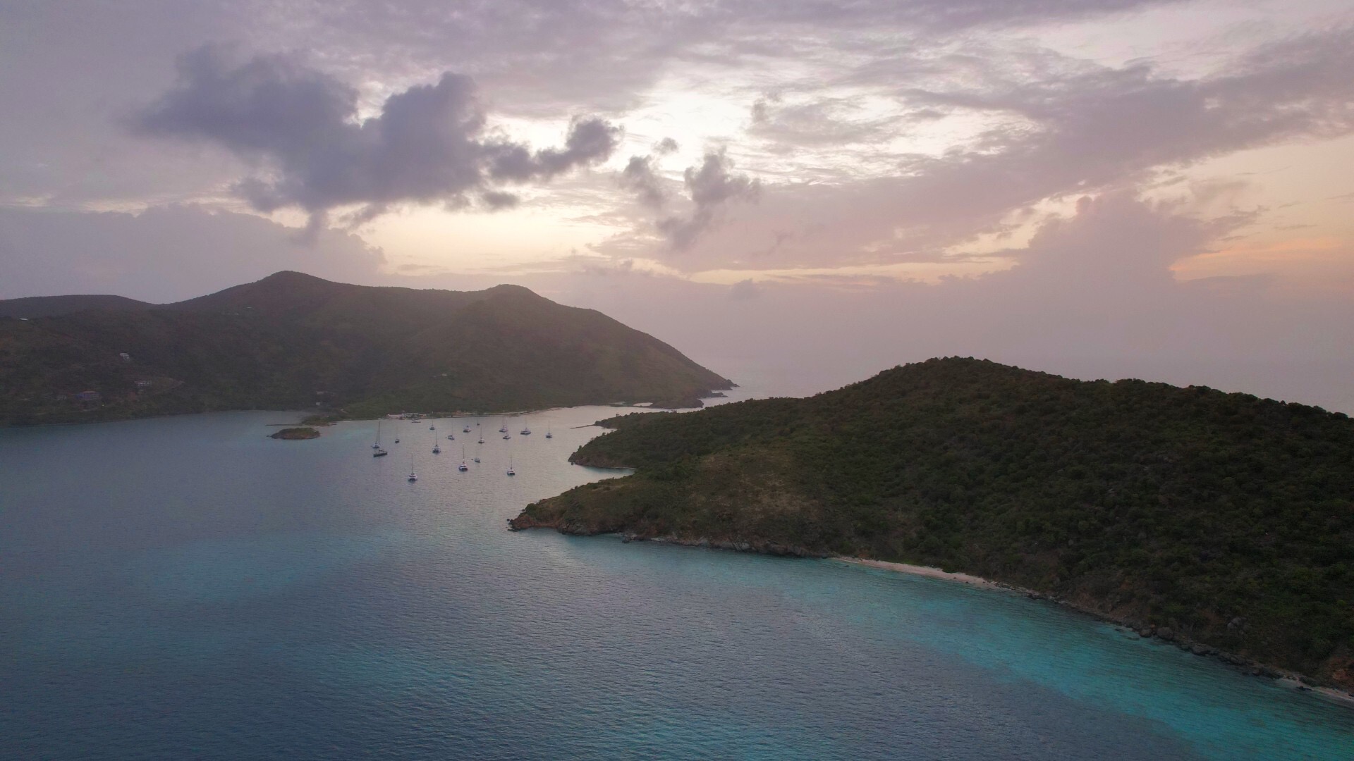 Little Jost Van Dyke, adjacent to Diamond Cay, offers tranquil anchorage, B-Line Beach Bar, hiking to Bubbly Pool, and nearby Sandy Spit.