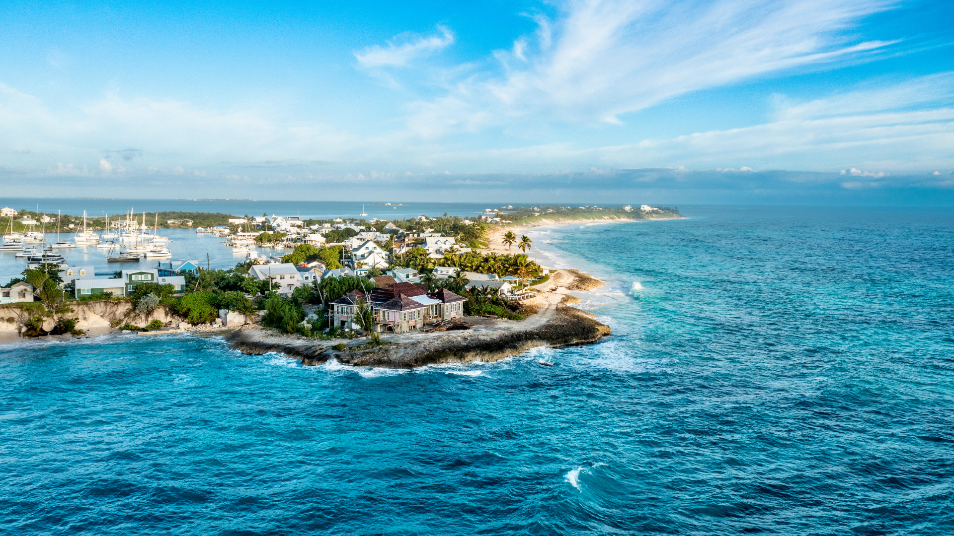 Explore Hope Town on Elbow Cay, Abaco, Bahamas. Famous for its candy-striped lighthouse, charming streets, and pristine beaches.