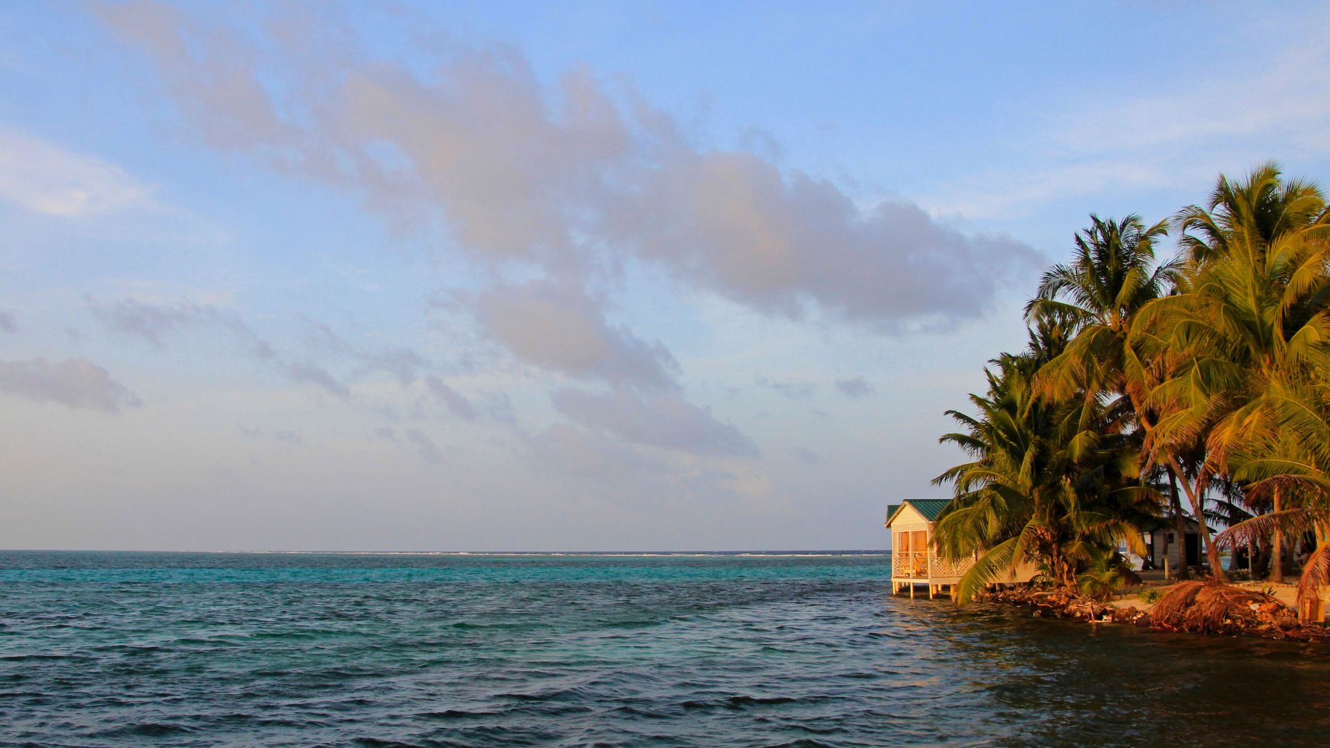 Tobacco Caye, Belize: A beautiful, palm-fringed island offering excellent snorkeling, fishing, and relaxation. Anchor safely and explore vibrant marine life.