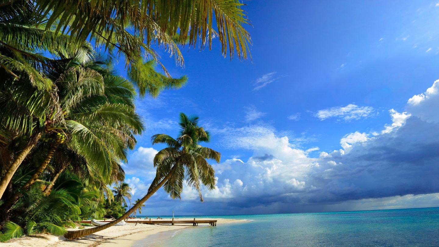 Explore the stunning Ranguana Caye in Belize with secure moorings, excellent snorkeling, and a lively beach bar. A must-visit for yacht charters.