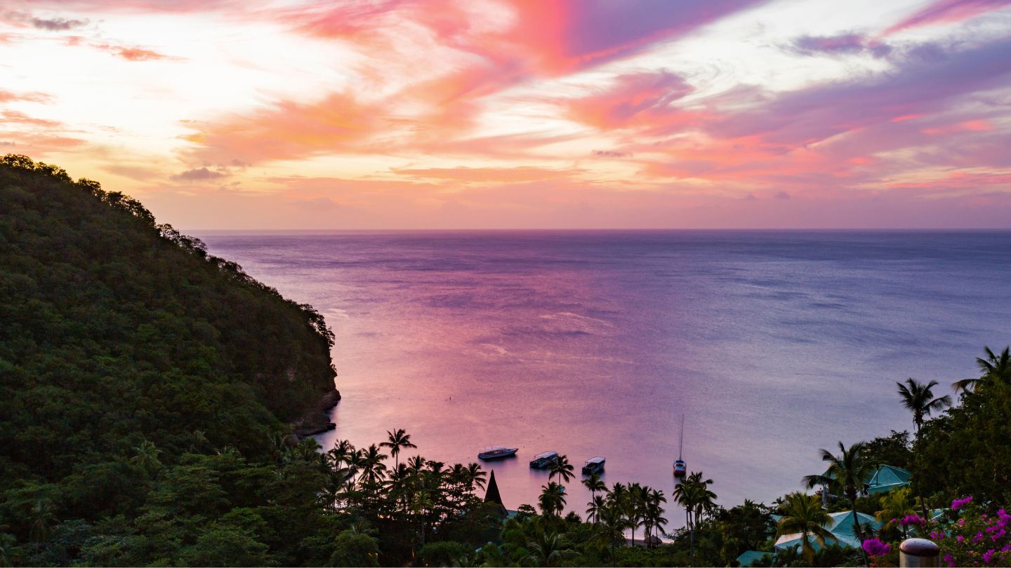 Enjoy snorkeling and stunning views of the Pitons at Anse Chastanet, St Lucia, a picturesque bay with pristine beaches and clear waters.