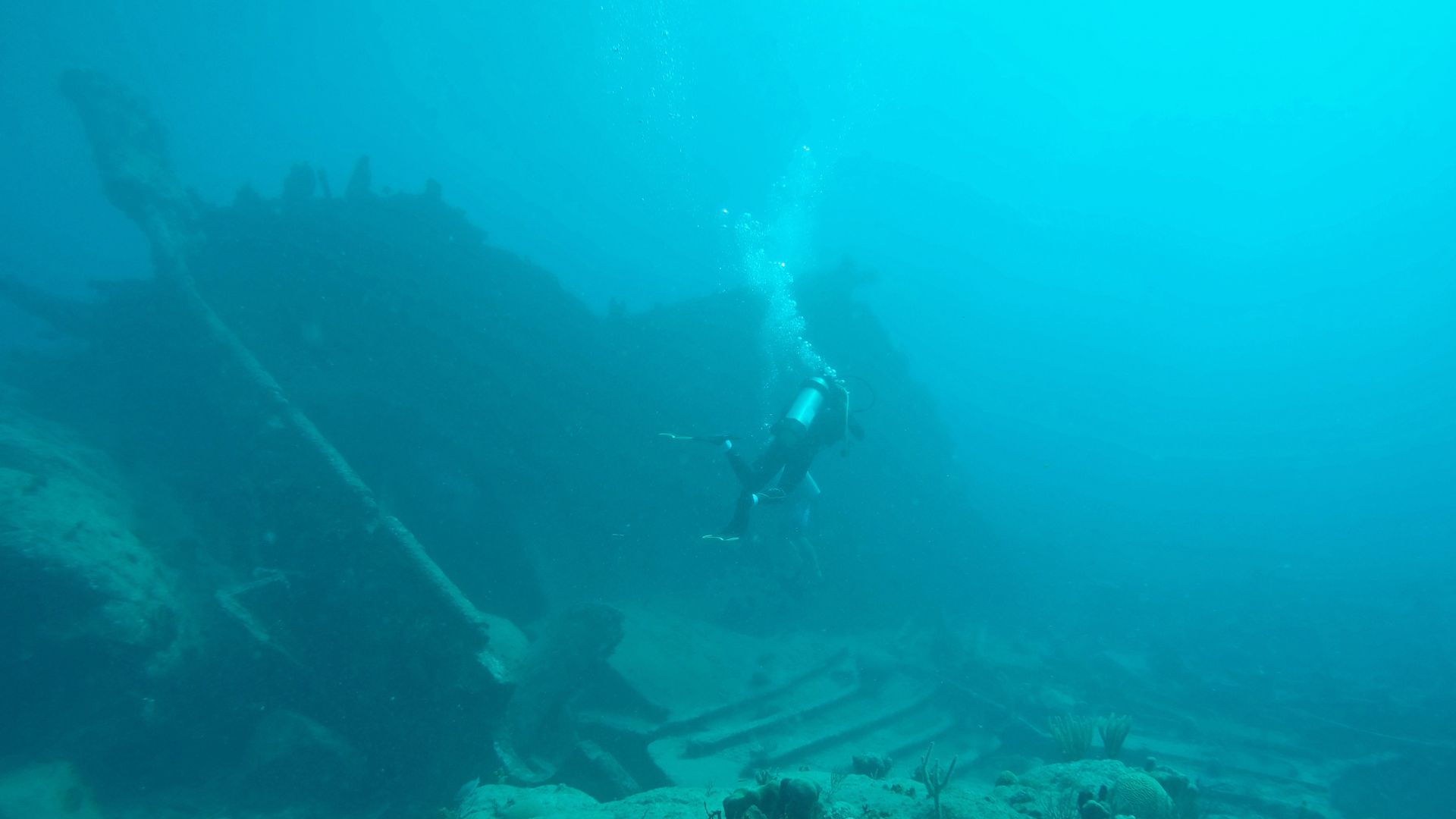 Scuba diving yacht charter destinations ranked: the BVI's wrecks, Belize's Great Blue Hole, French Polynesia's shark passes, and the easy reefs of the Exumas.
