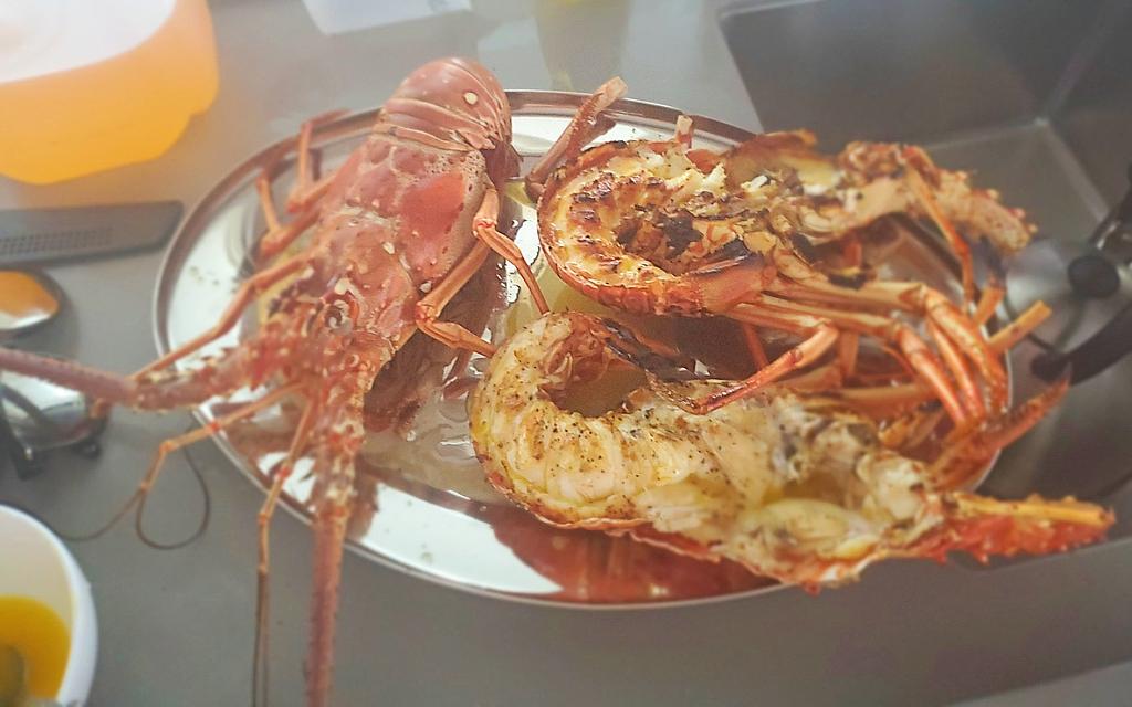 Fresh grilled Anegada spiny lobster on the boat | We got these from a local since tourists are not allowed to take them