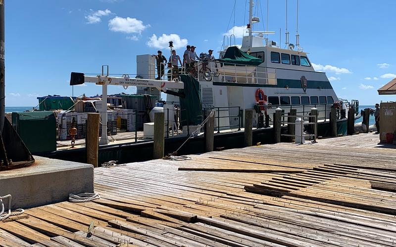 Some damage from storm swell to the Garden Key dock is visible, but many decking boards are still in place | NPS
