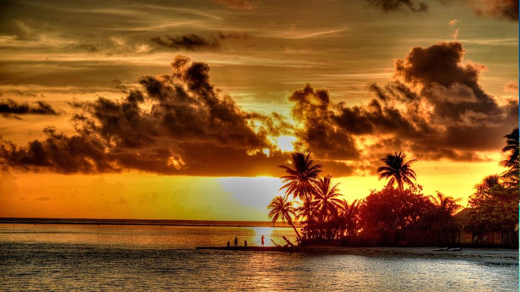 Sunset over a French Polynesian motu