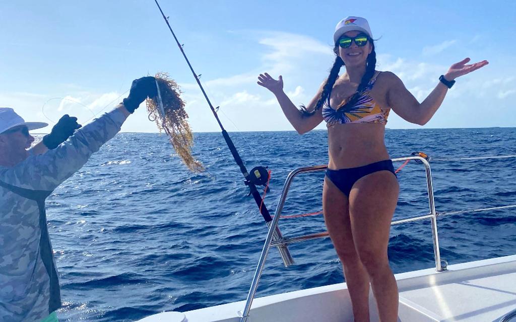 Clearing sargassum weed from our lures on a recent bareboat charter trip