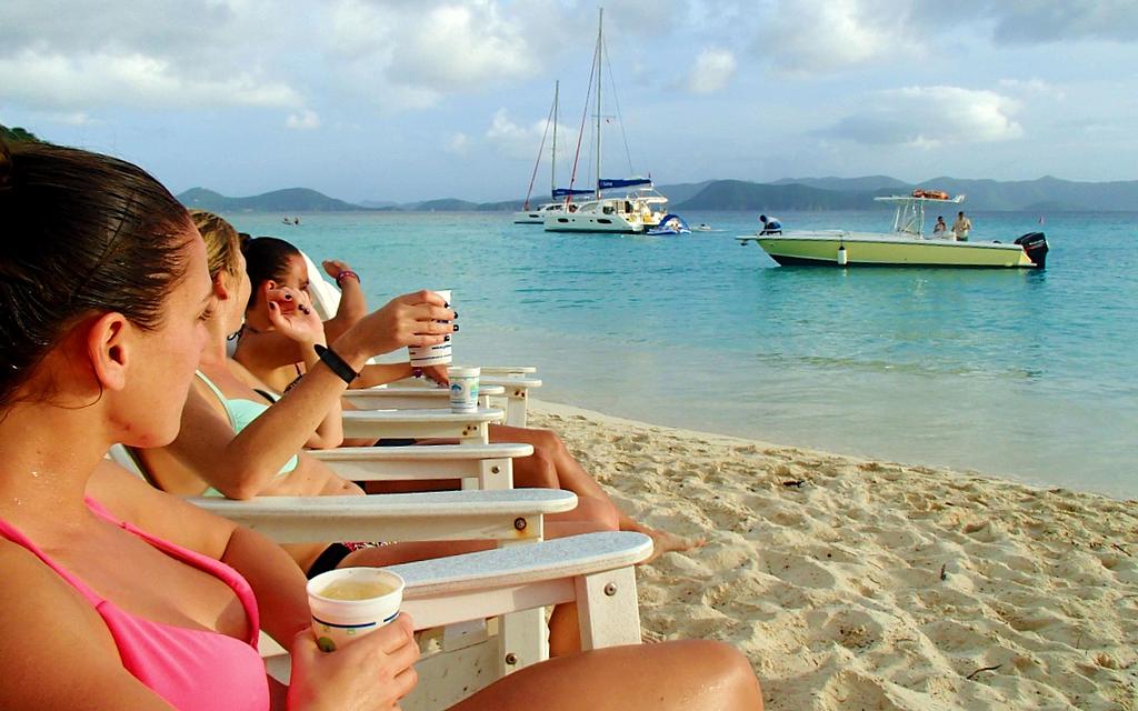 Lady crew members lined up with painkillers at the Soggy Dollar Bar in BVI.